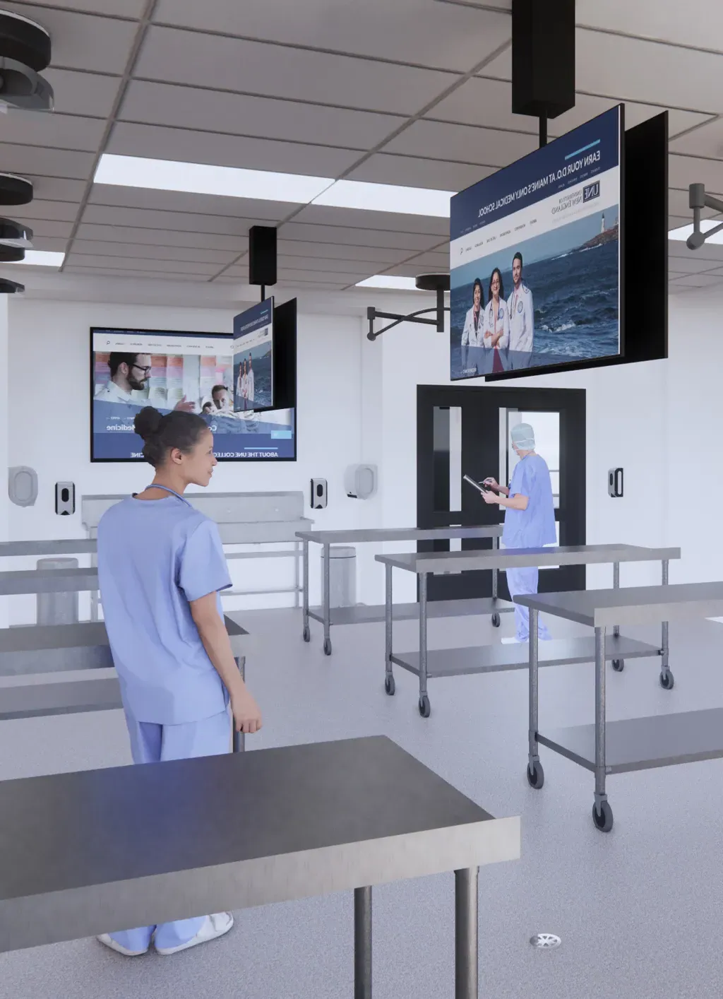 A rendering of the upcoming anatomy lab in the new C O M building showing tv screens and silver tables