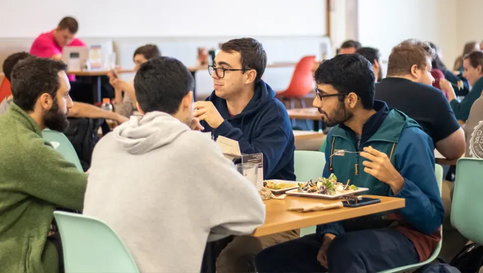 A group of students eating in the Commons dining room