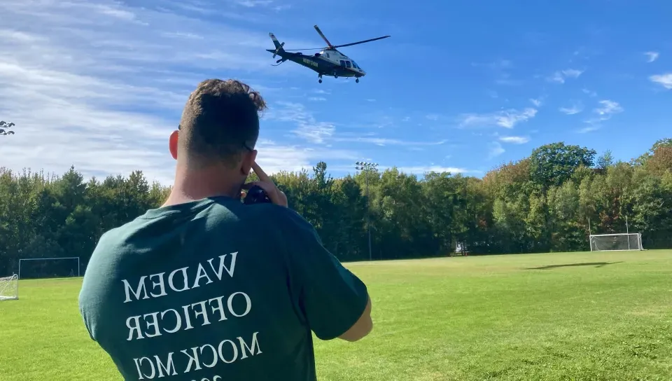 A UNE student watches LifeFlight takeoff. 