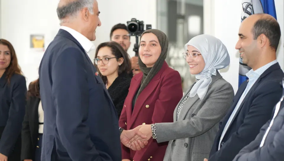 Ambassador Talwar greets a student