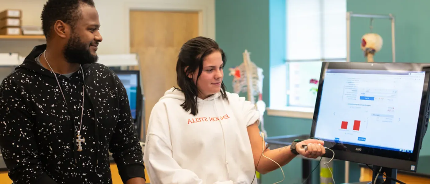 Two U N E health professions students use a computer program