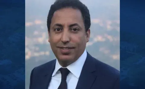 Headshot of Younes Abouyoub against a blue backdrop