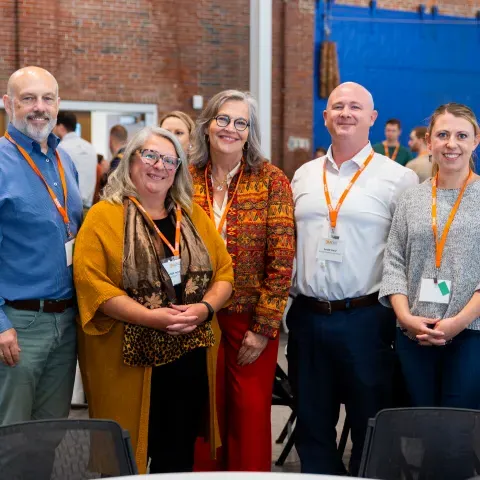 A group of UNE researchers and administrators pose for a photo