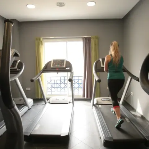 A woman runs on a treadmill